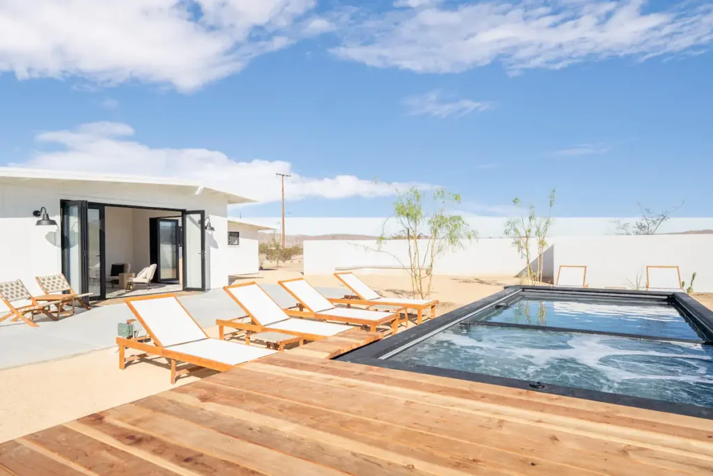 Desert backyard with plunge pool and four lounge chairs
