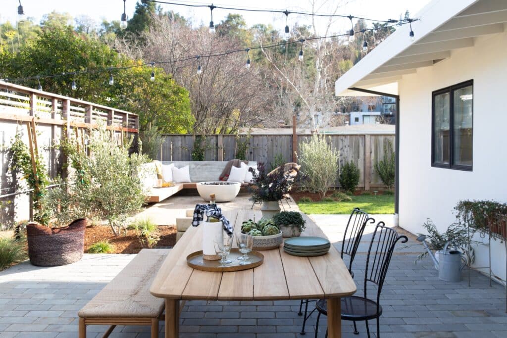 Backyard with an outdoor dining space and lounge area with fire pit