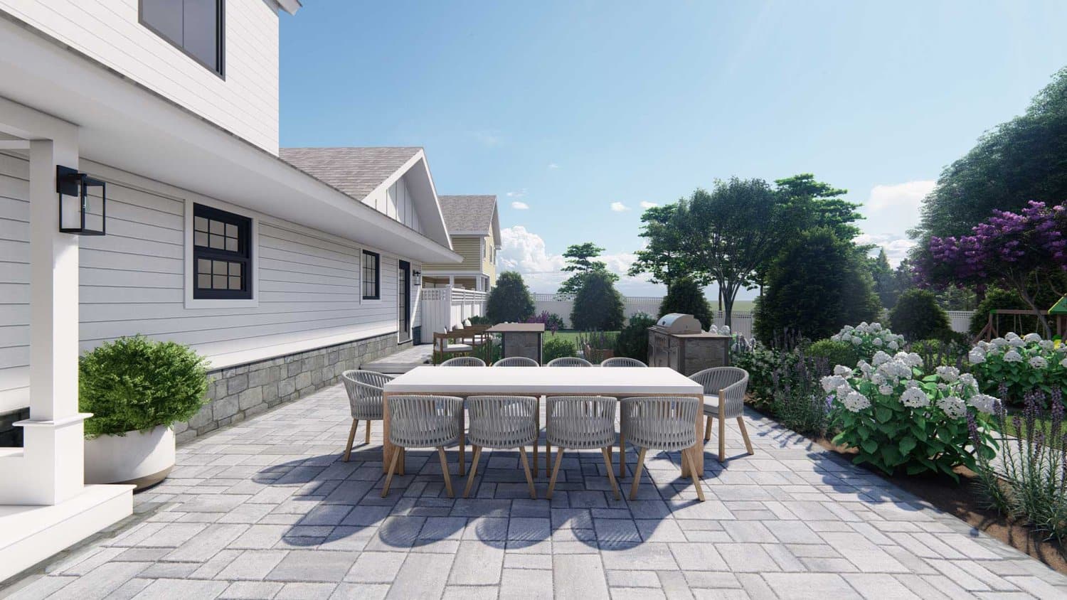 Long Island concrete paver front yard with dining area, outdoor kitchen, flowers and trees