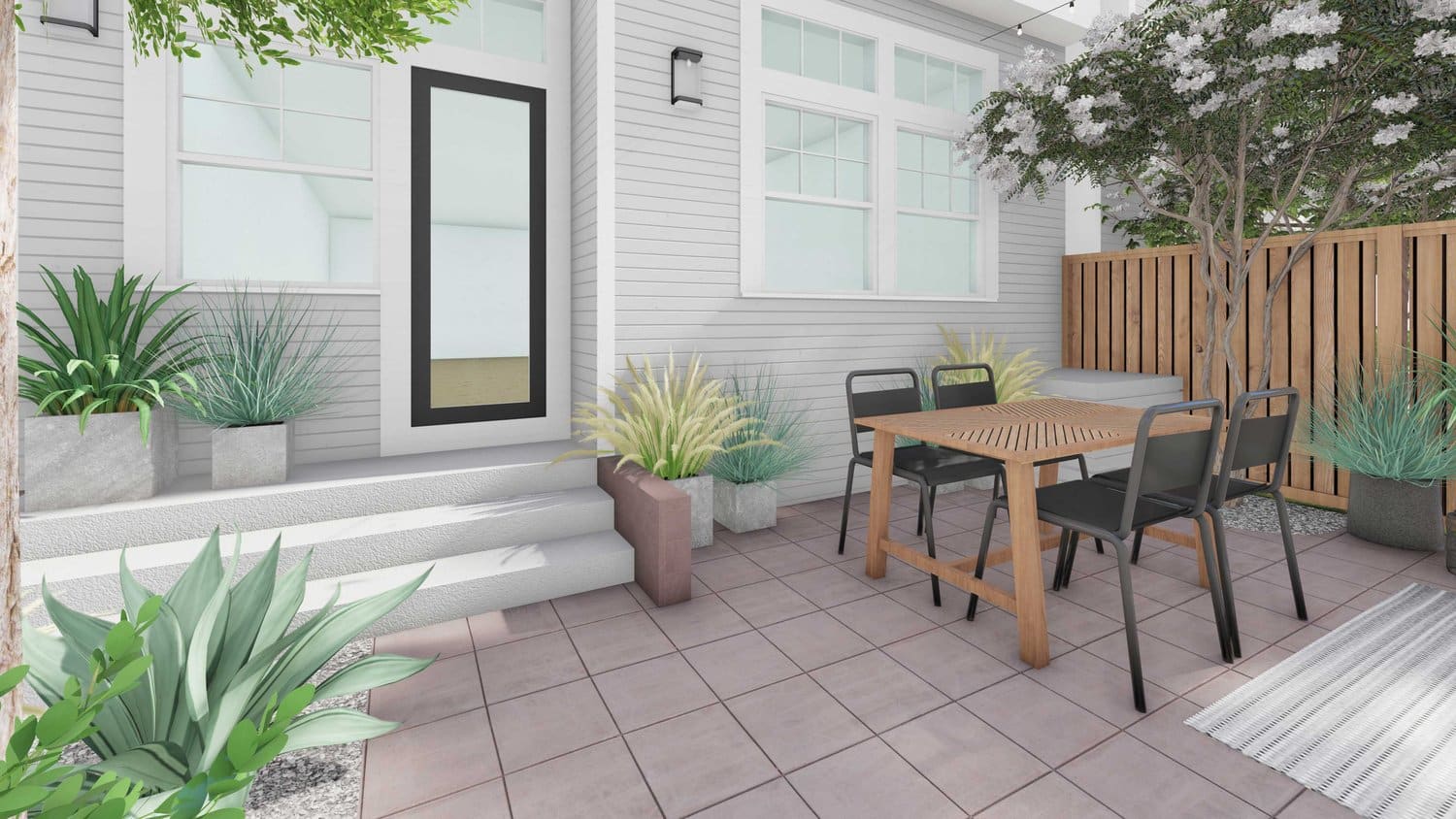 front yard with concrete paver flooring, concrete steps, plants and tree in gravel, alongside planters and dining area