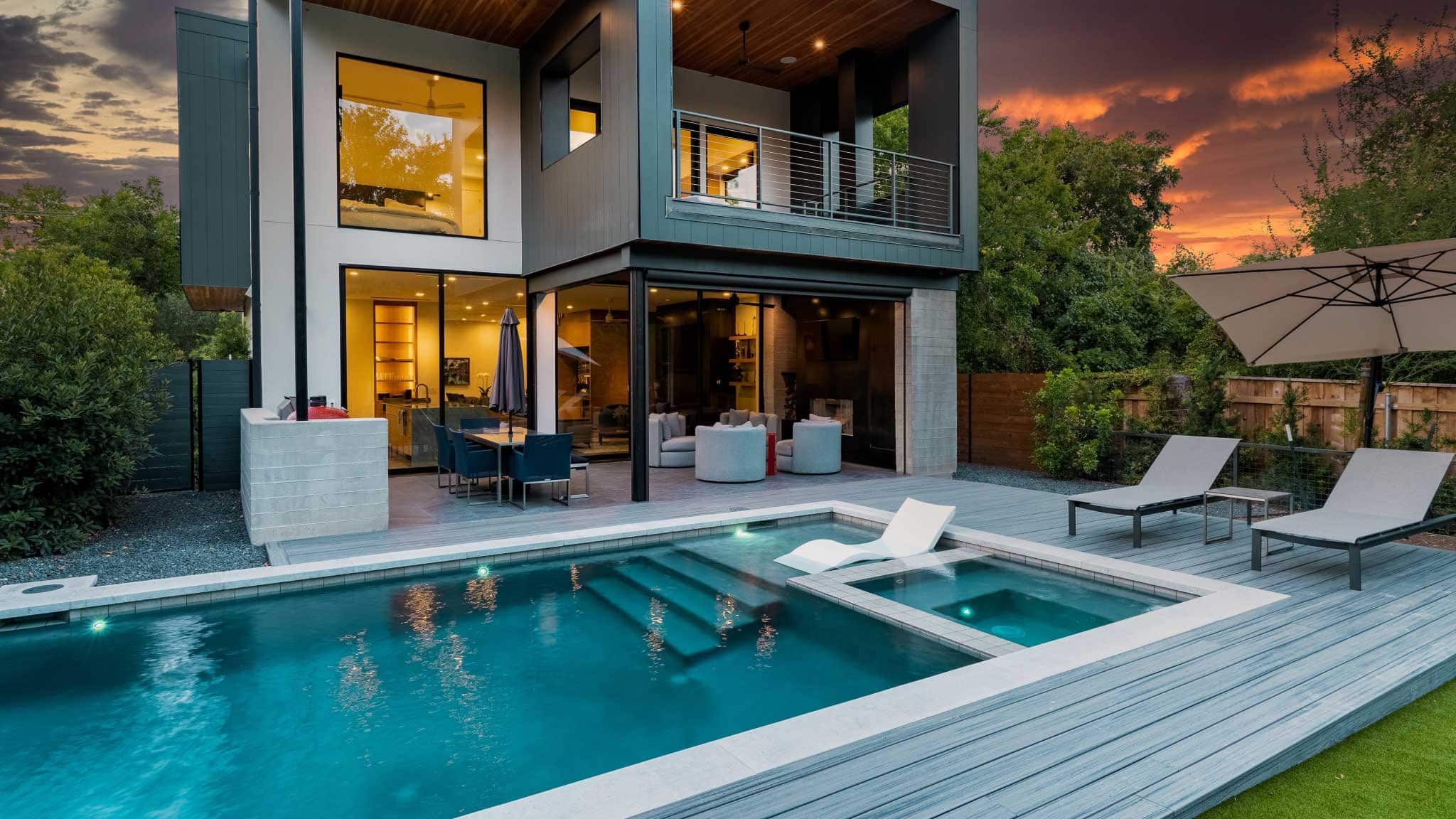 Modern home and backyard with pool and lounge area