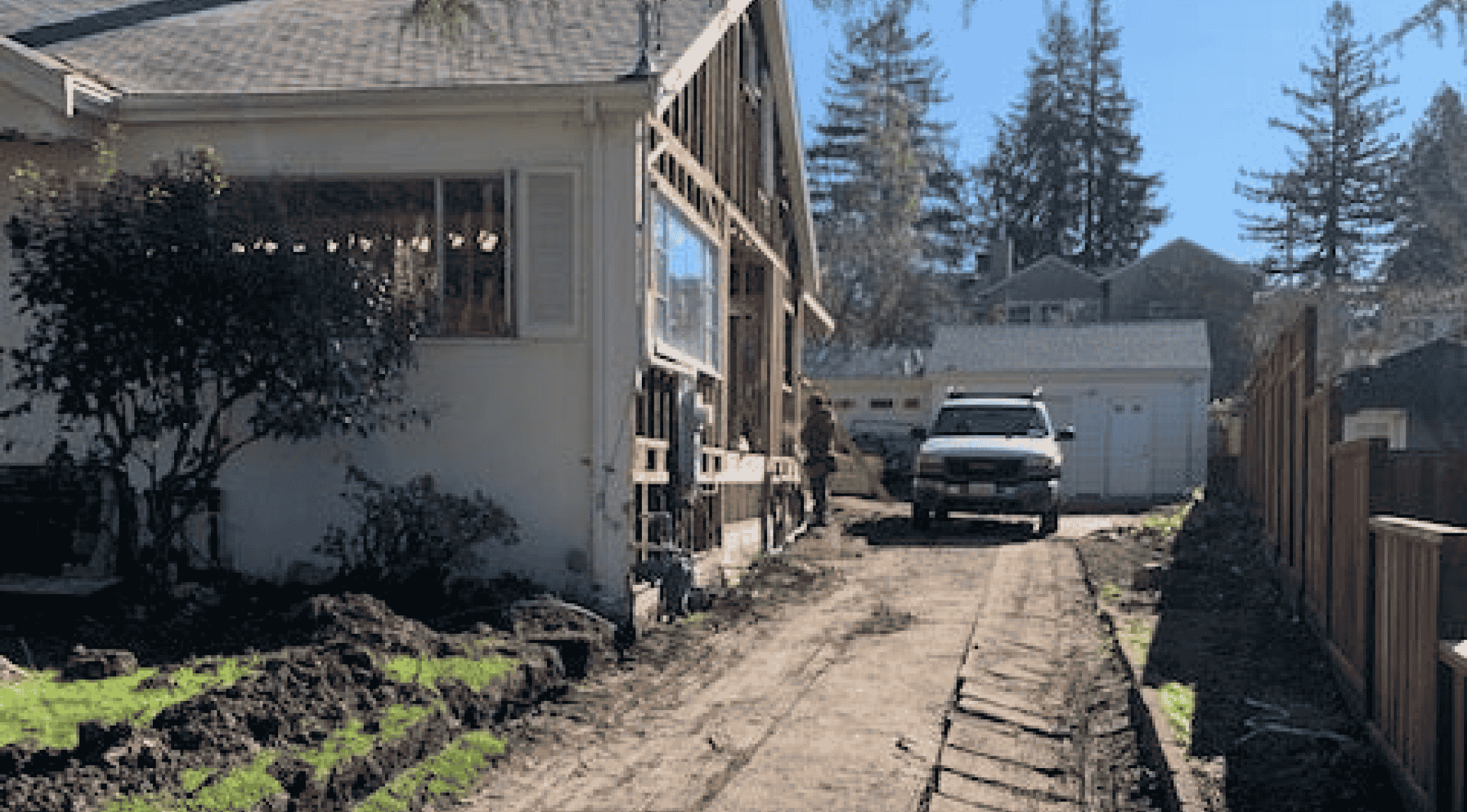 Before photo of bare side yard and under-construction home