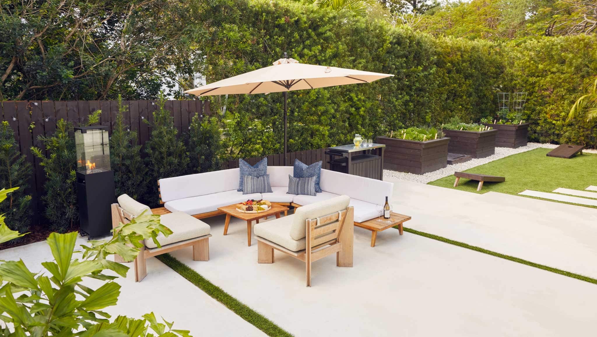 Concrete patio with stylish outdoor lounge furniture and outdoor umbrella