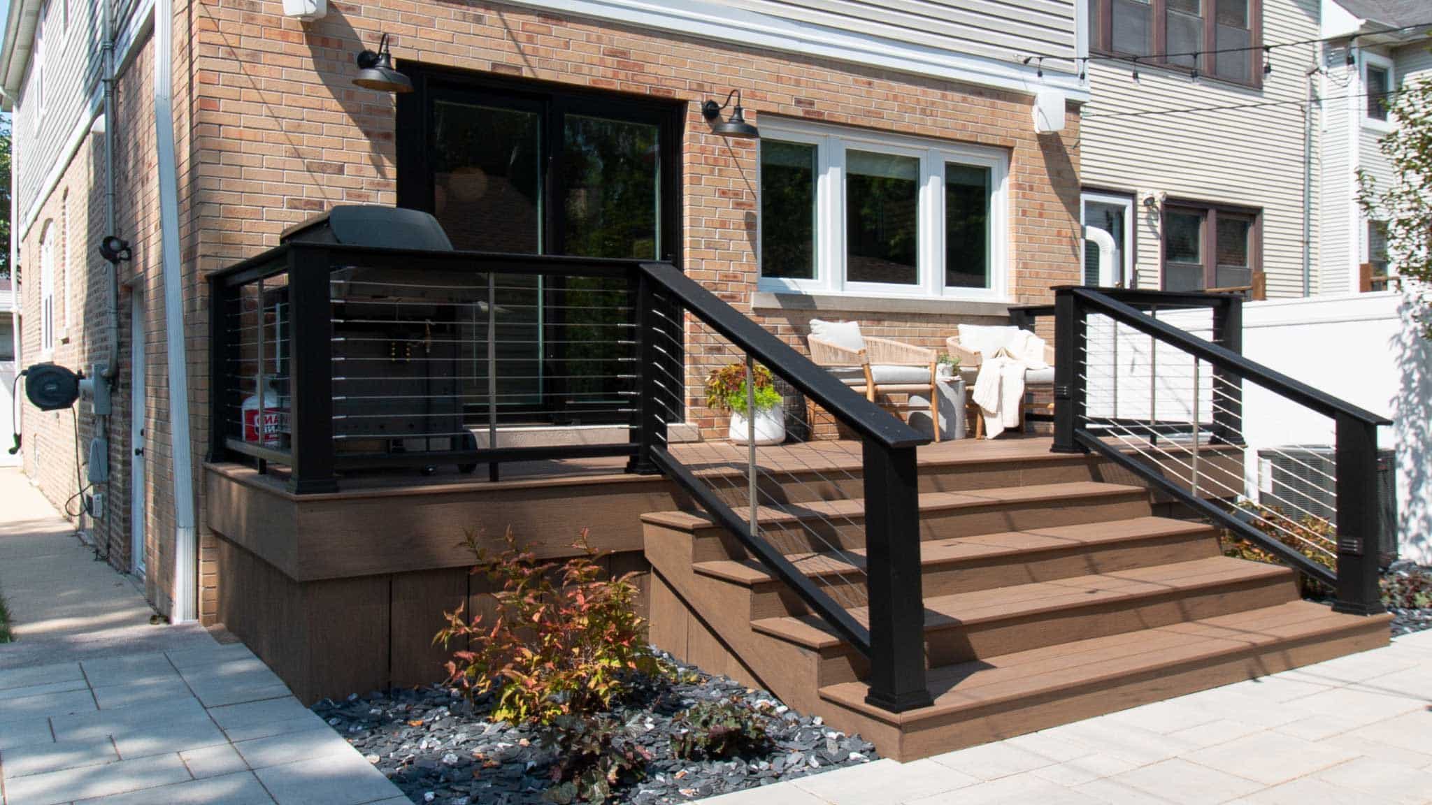Clean modern backyard deck with black railing