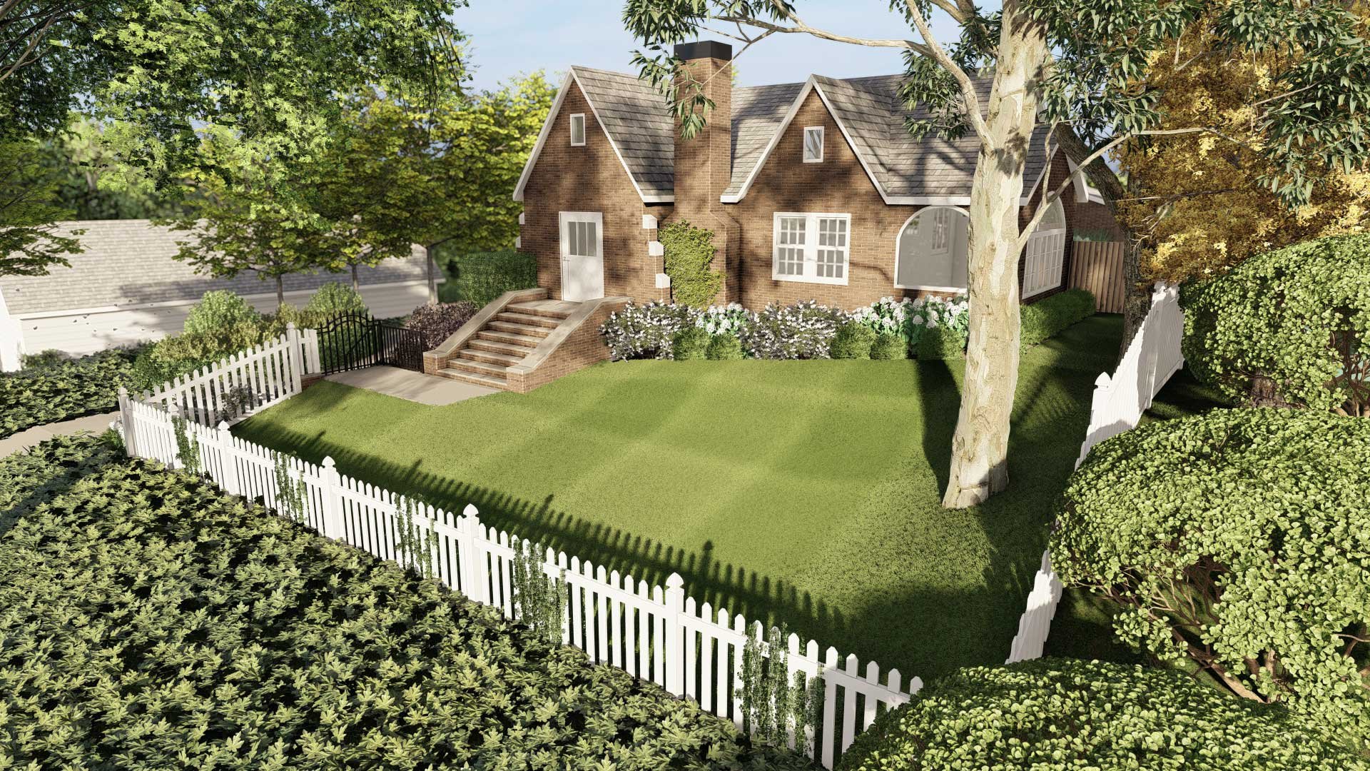 A sloped front yard covered with lawn grass, short fence next to plants and trees