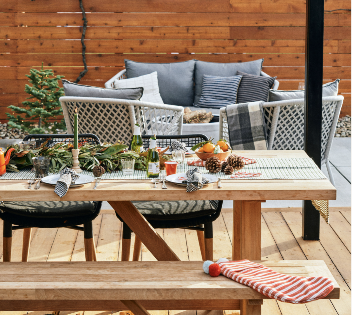 Outdoor dining set on a deck and a sitting area around a firepit