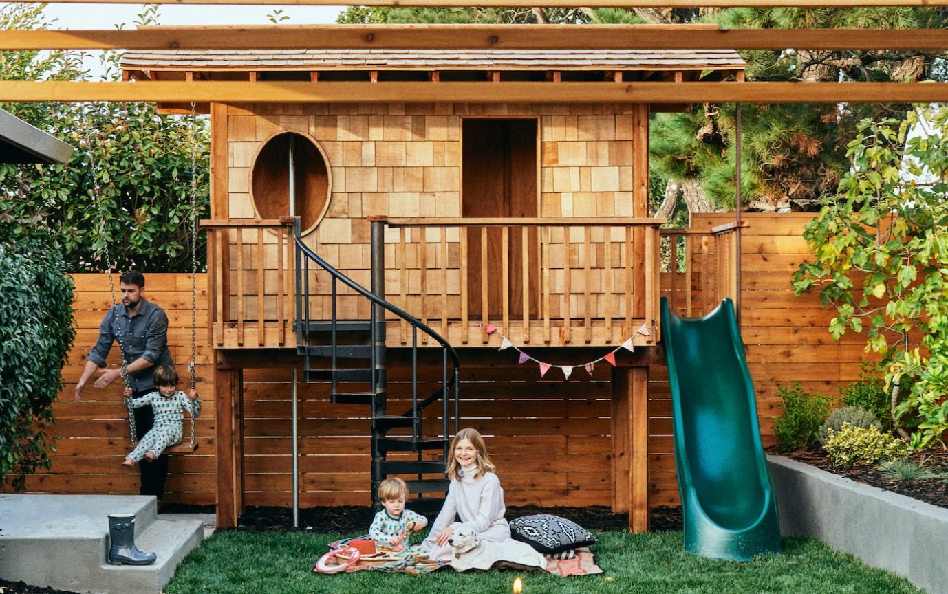 Kid-friendly yard with treehouse, swing-n-slide and decorative plants