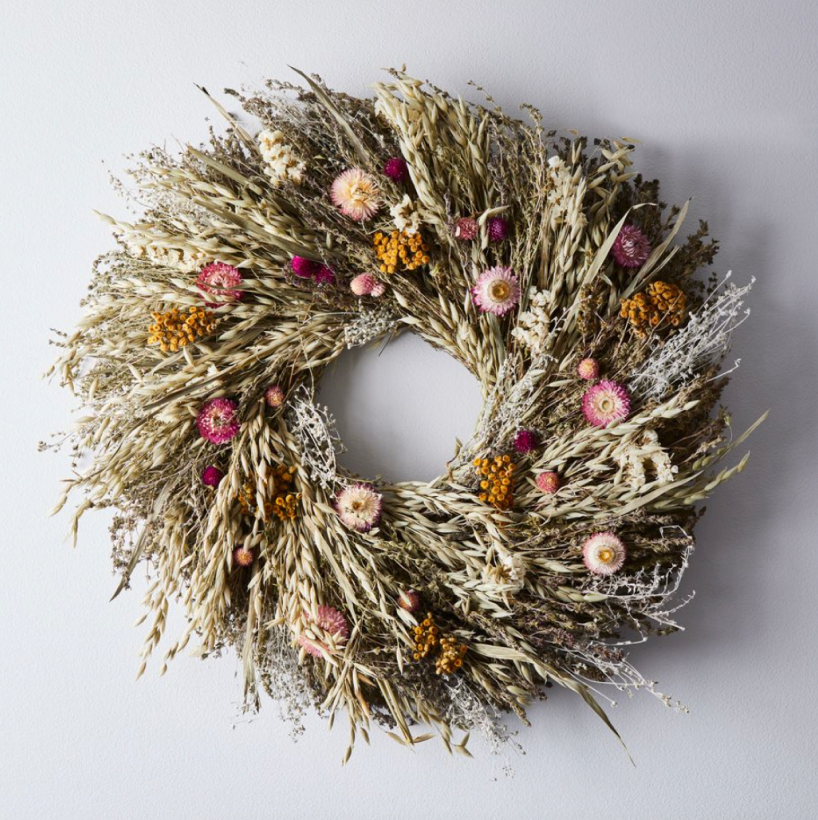 12 Spring Prairie Wreath - Spotlight spring’s bounty of dried blossoms, herbs, and grains on your front door. Handwoven and gathered from a family farm, Creekside Farm’s wreath will usher in the new season with wafts of sweet-smelling savory and bear grass every time you walk through the door.SHOP NOW >” loading=”lazy”></noscript><br/><img decoding=