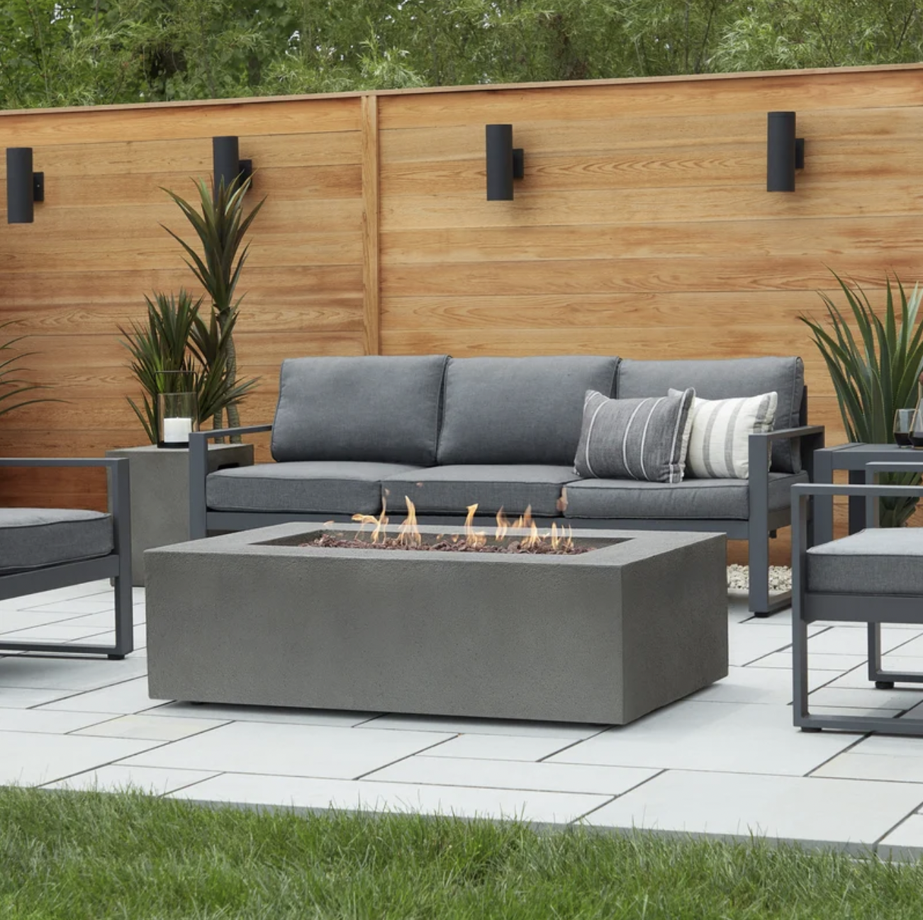 Baltic Concrete Fire Pit  - The concrete finish of this rectangular propane gas fire pit table will blend well with warm, modern landscaping. Spacious at more than four feet long, there’s plenty of room for everyone to gather around—and with a 65000 BTU output, plenty of heat as well. SHOP NOW >” loading=”lazy”></noscript><br />
<img decoding=