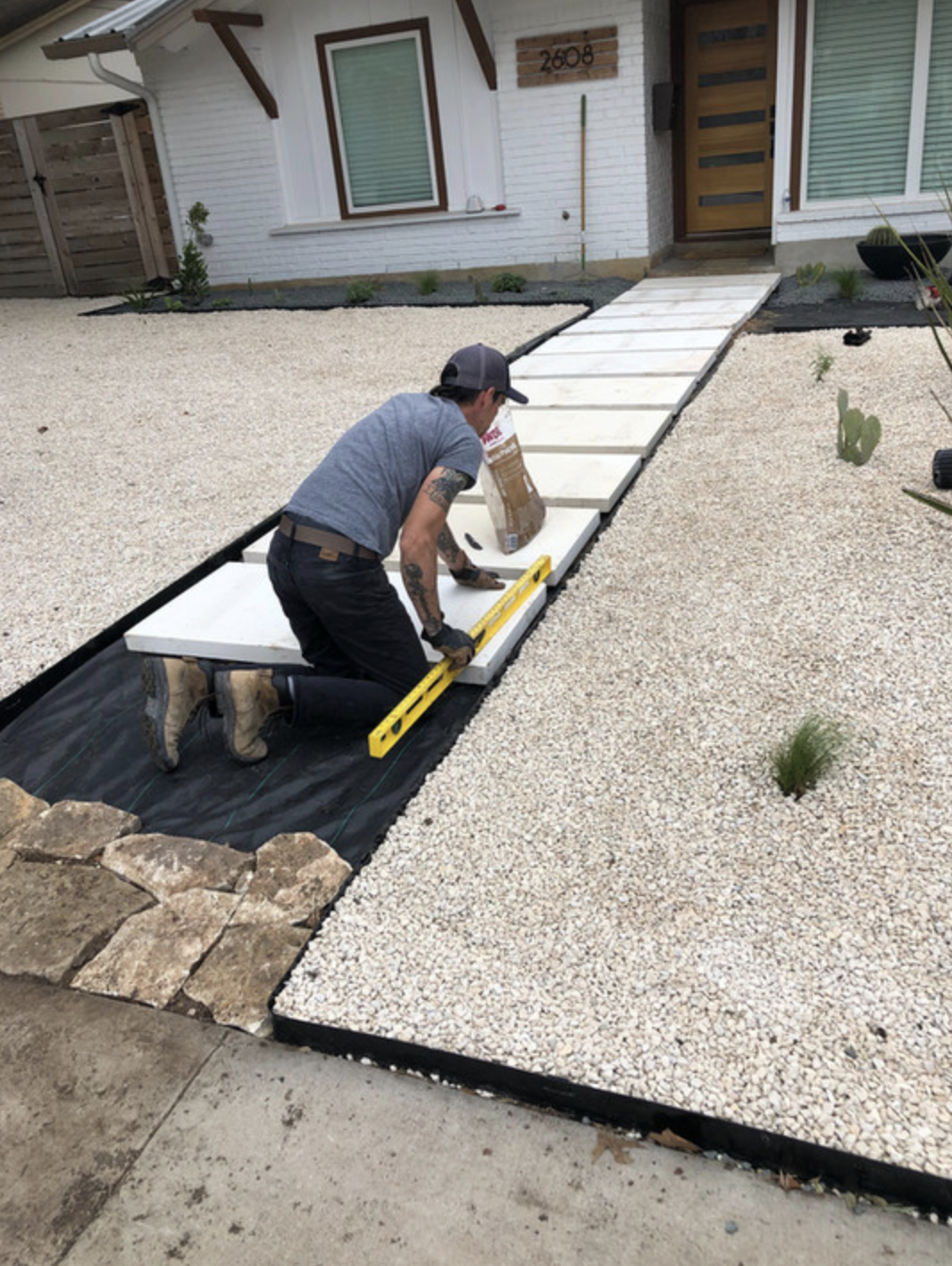 Stone-paved walkway being constructed 