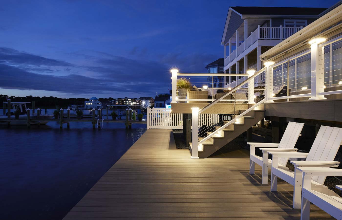 A waterfront property with a deck and lounge chairs