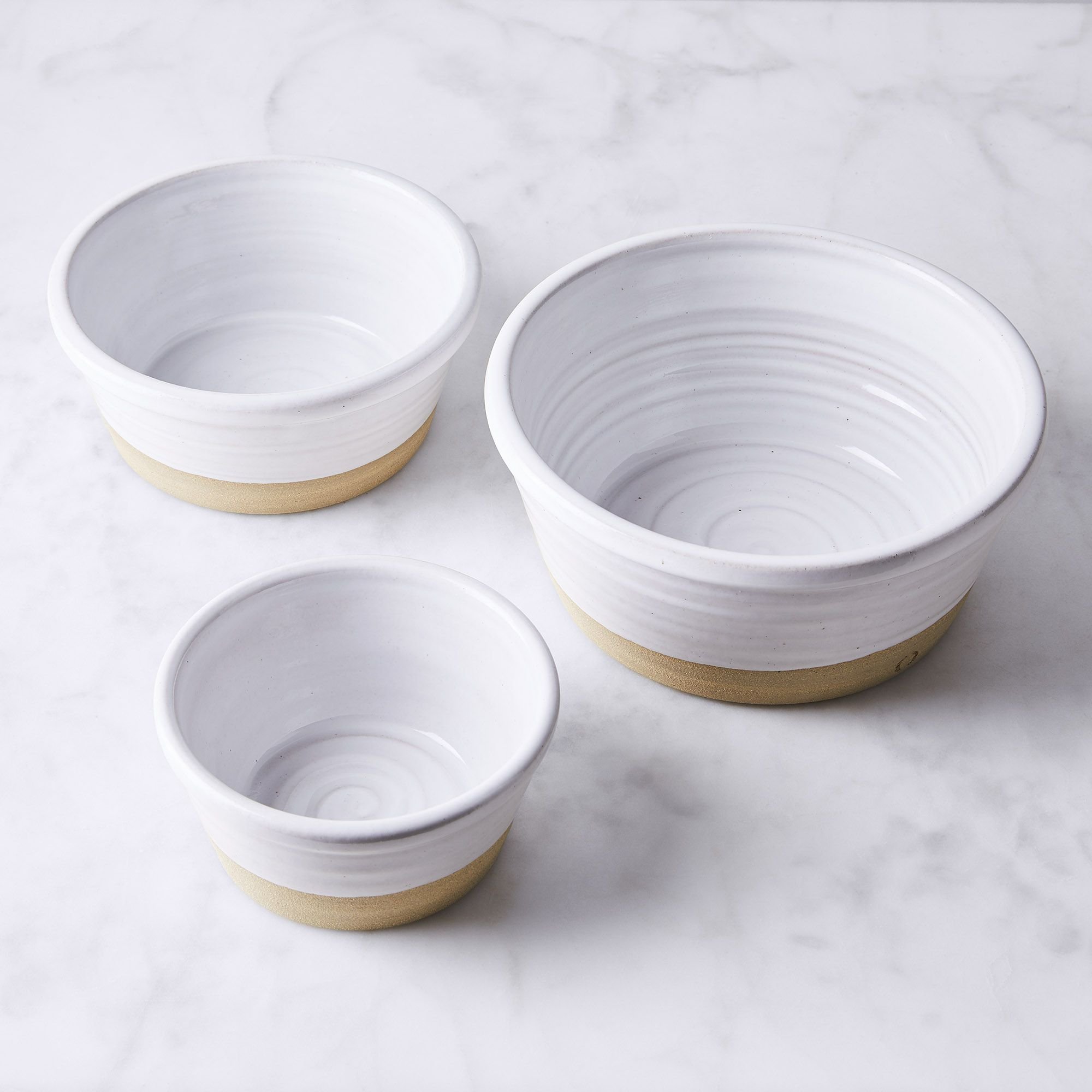 White brown ceramic dog bowls in three sizes (small, medium, large).