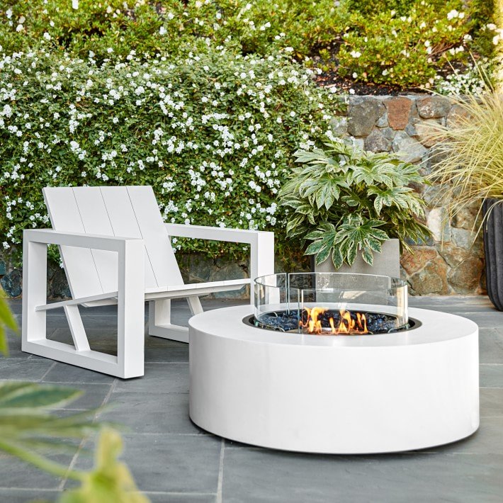 Williams Sonoma Home’s EcoSmart Fire Table Ark 40 - Masterfully crafted from composite concrete, the Ark 40 operates with three fuel-type options: plumbed natural gas and liquid propane for outdoor use, or eco-friendly bioethanol for indoor/outdoor use. The round fire table yields a clean-burning flame and ample surface space for holding glassware and appetizers, the modern fire table creates an inviting space for relaxation.SHOP NOW >MORE MODERN FIRE PITS >” loading=”lazy”></noscript><br />
<img decoding=