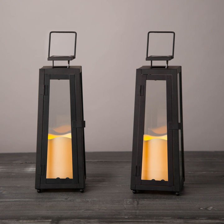 09 Quincy Solar Lanterns - You won’t regret adding these no-fuss black hurricanes to your list of must-haves this fall. Crafted of glass and metal, these sleek handled lanterns come with solar-powered flameless candles which, on a full charge, keep lit for up to eight hours.SHOP NOW >” loading=”lazy”></noscript><br/><img decoding=