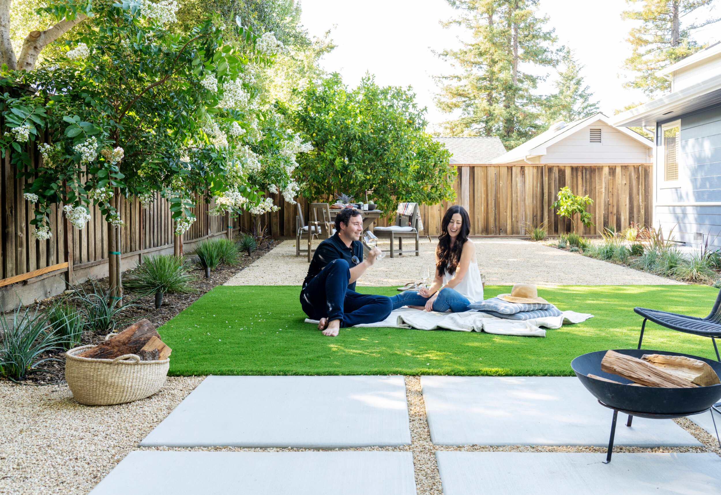 Turf in this Yardzen yard creates the perfect place to lay out a picnic blank and enjoy a glass of wine.