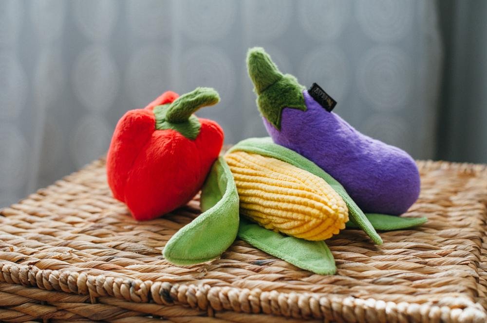 Needle felted red pepper, corn and egg plant on a woven basket box.