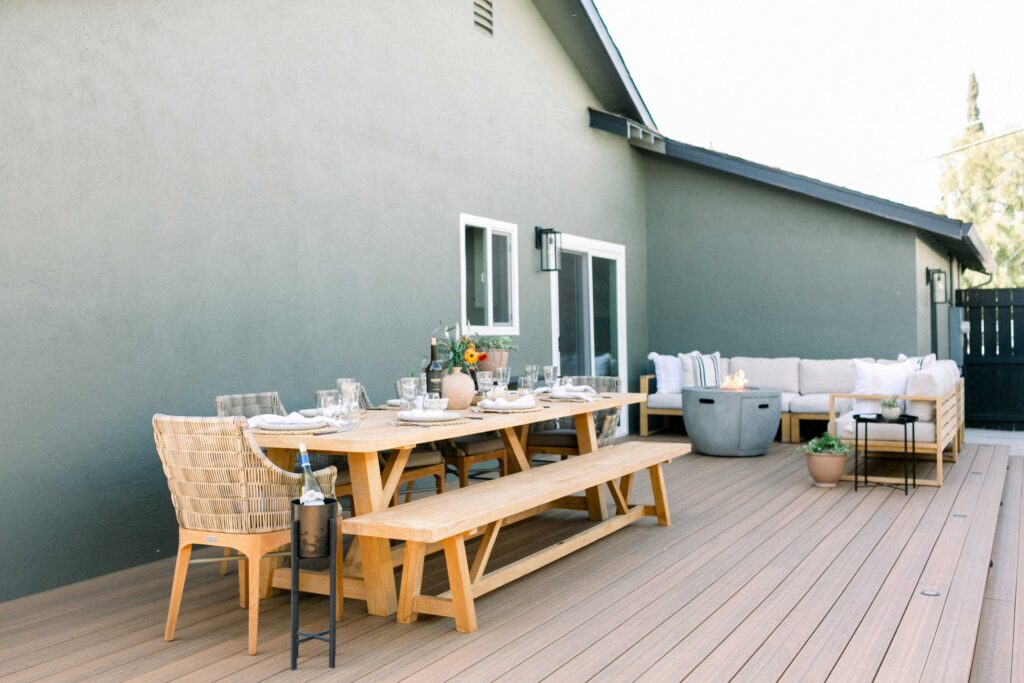 Side yard with outdoor dining table area and fire pit lounge area