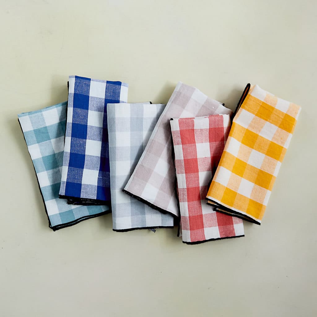 Six gingham napkins laid overlapping each other