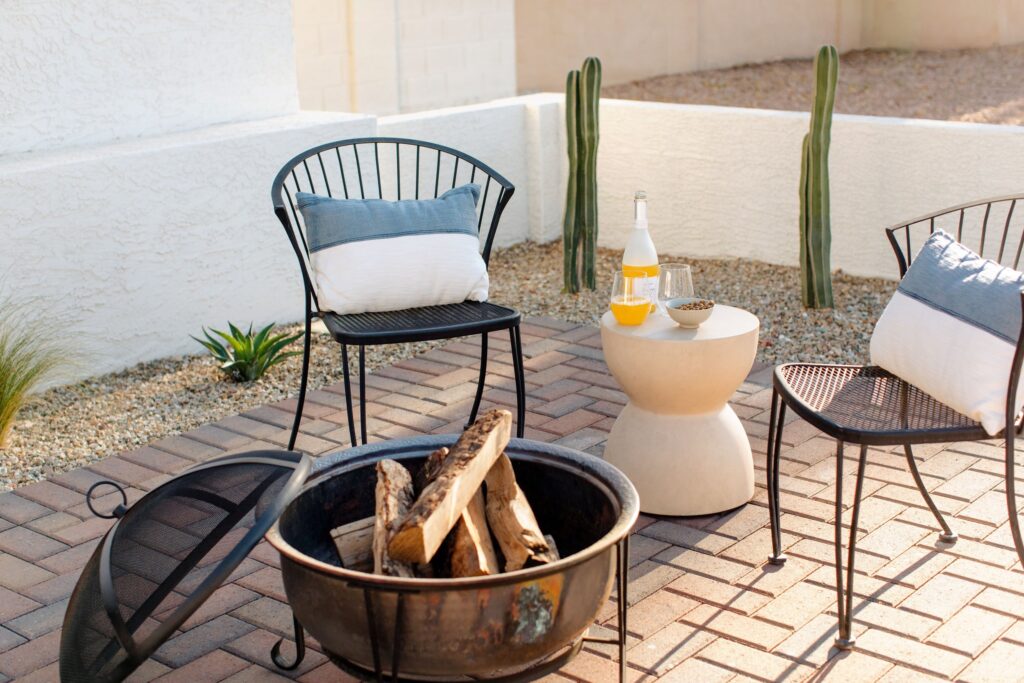 Social front yard fire pit with seating area in Yardzen landscape design