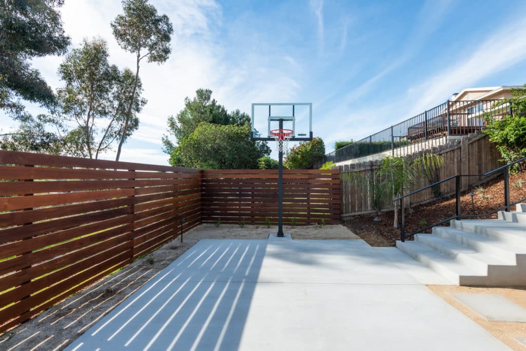 Yardzen backyard design with basketball hoop and court