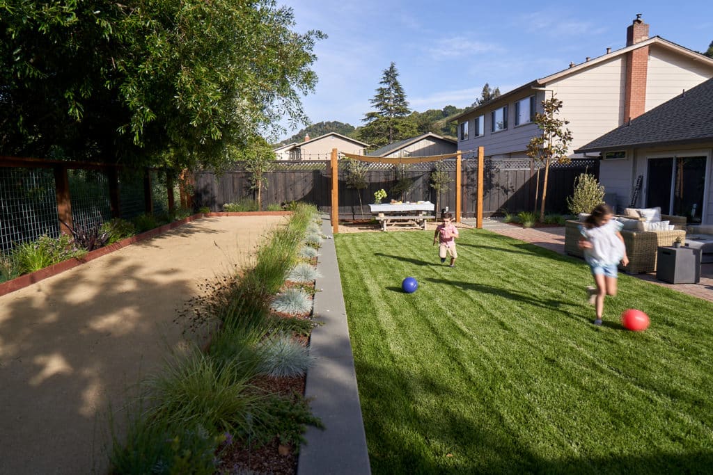 Yardzen backyard landscape design with bocce court and kid-friendly lawn area