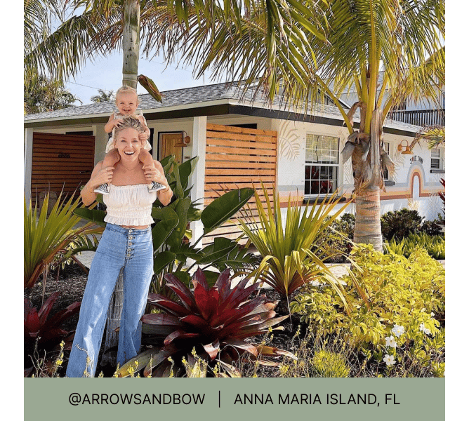 Woman with toddler on her shoulders in tropical style front yard with heading that reads @arrowsandbow Anna Maria Island, FL