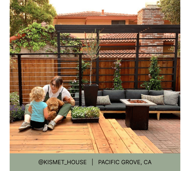 Woman, child, and dog sitting on a wooden deck with brick patio and fire pit seating area in background and heading that reads @kismet_house Pacific Grove, CA