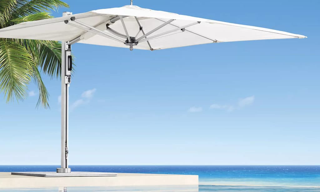 Tucci Bay Master Cantilever Umbrella product photo with ocean view and palm in the background
