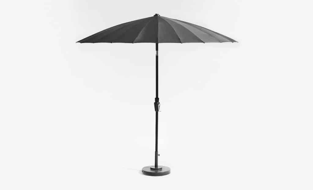 The Dome outdoor umbrella by Crate and Barrel with black parasol-shaped canopy and black frame