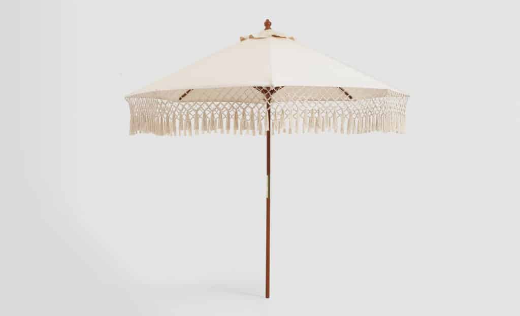 The Natural Fringe Umbrella canopy on a wooden frame