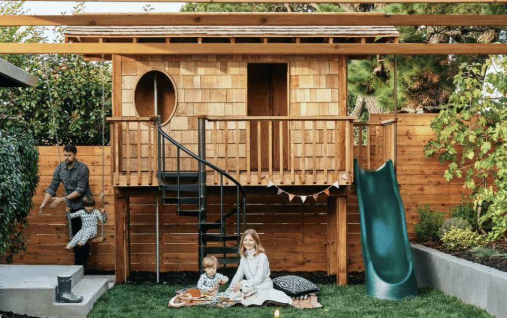 Yardzen backyard landscape design featuring swing set and playhouse with slide