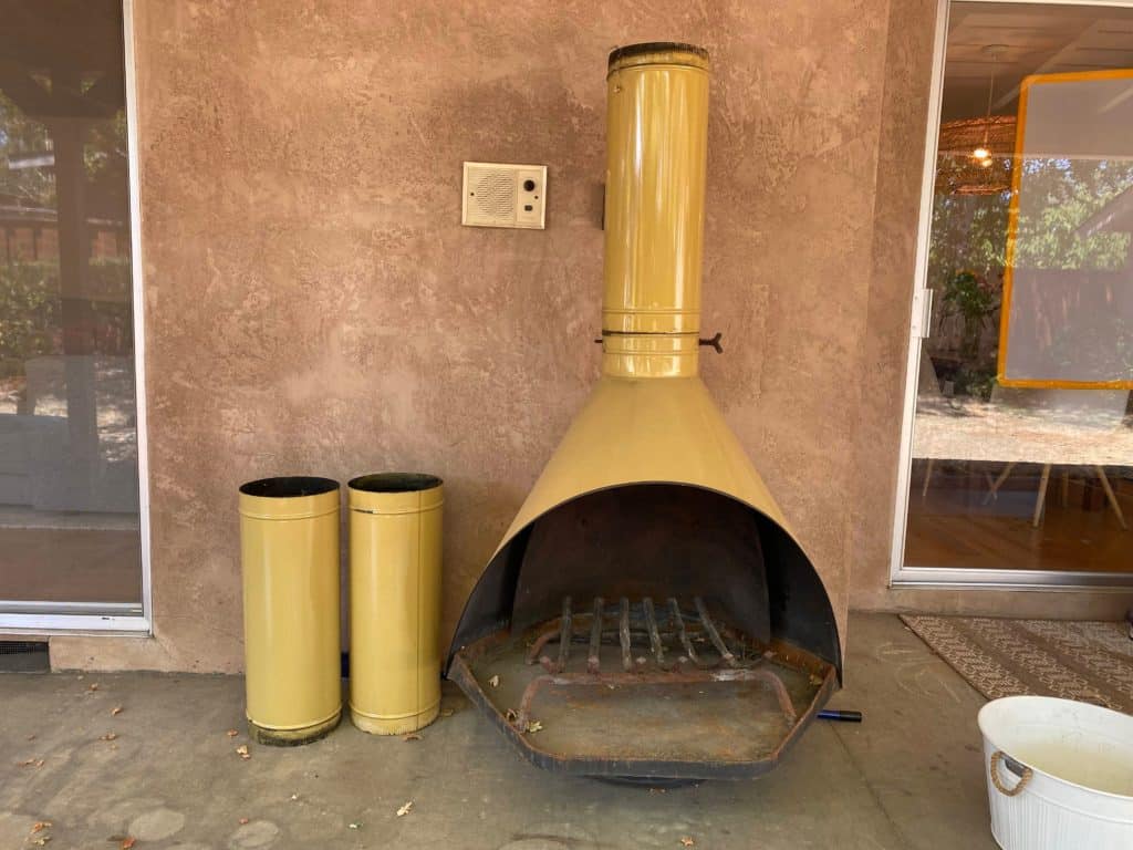Mid Century Modern outdoor fireplace on weathered concrete patio