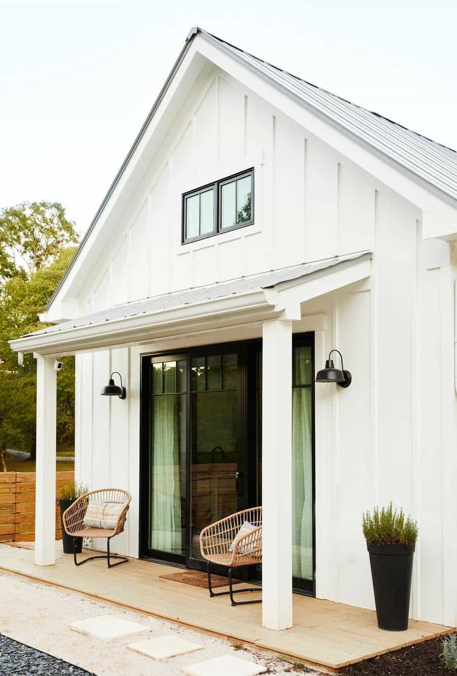 Porch of the ADU guest house with two chairs and a glass door/ Decomposed granite pathway leads up to the porch. 