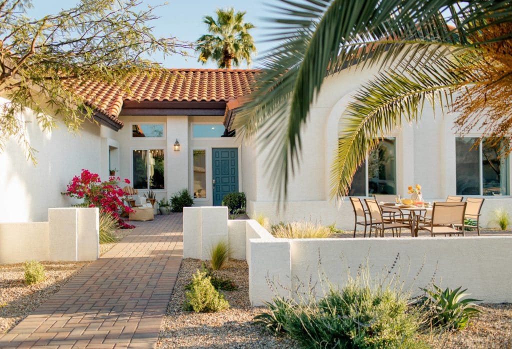spanish-style home with low stucco front yard wall