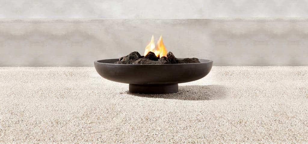 black cement fire pit in low modern dish shape