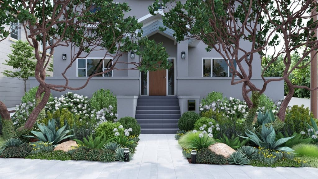 Front yard design for grey-colored home with lush plantings including trees, groundcover, grasses, and flowering shrubs