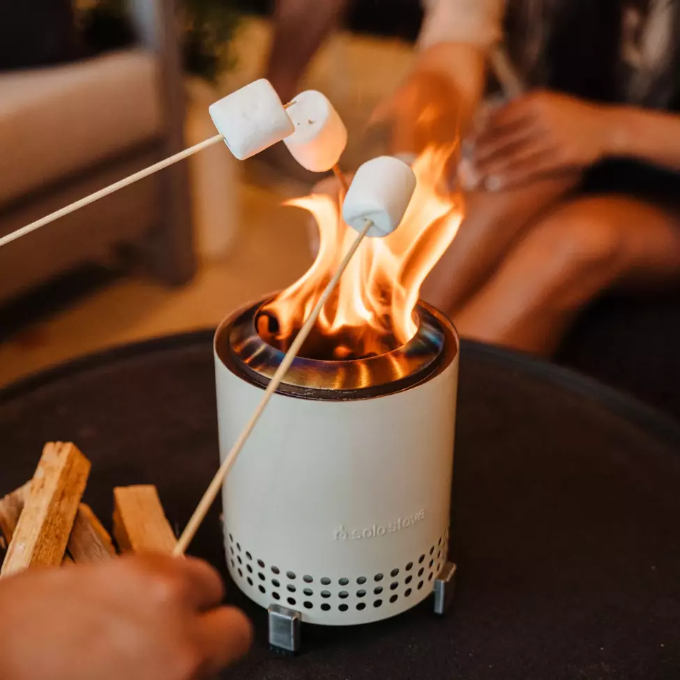 Roasting marshmallows on miniature fire pit on table top