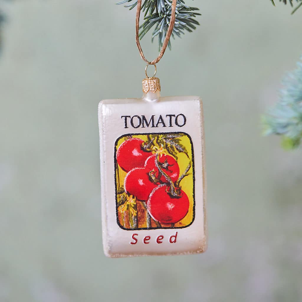 Tomato seed packet ornament handing on tree branch