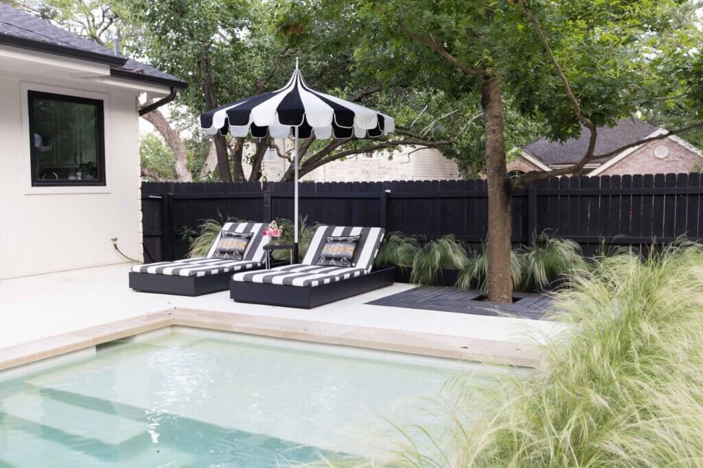 Clean and contemporary sun loungers and matching umbrella