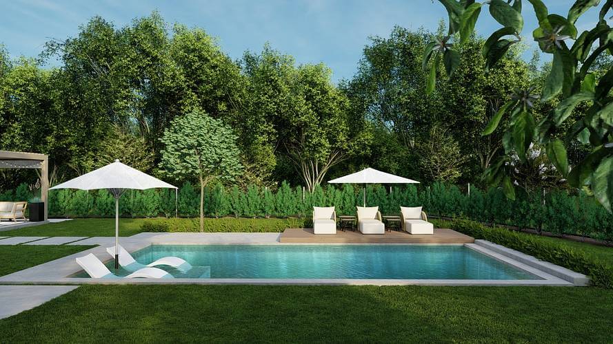 large backyard pool with three lounge chairs.