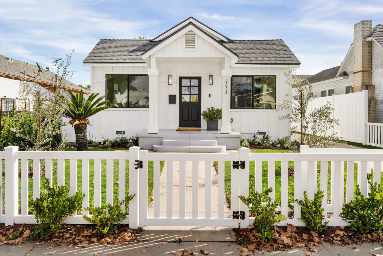 Modern farmhouse style home with white picket fence