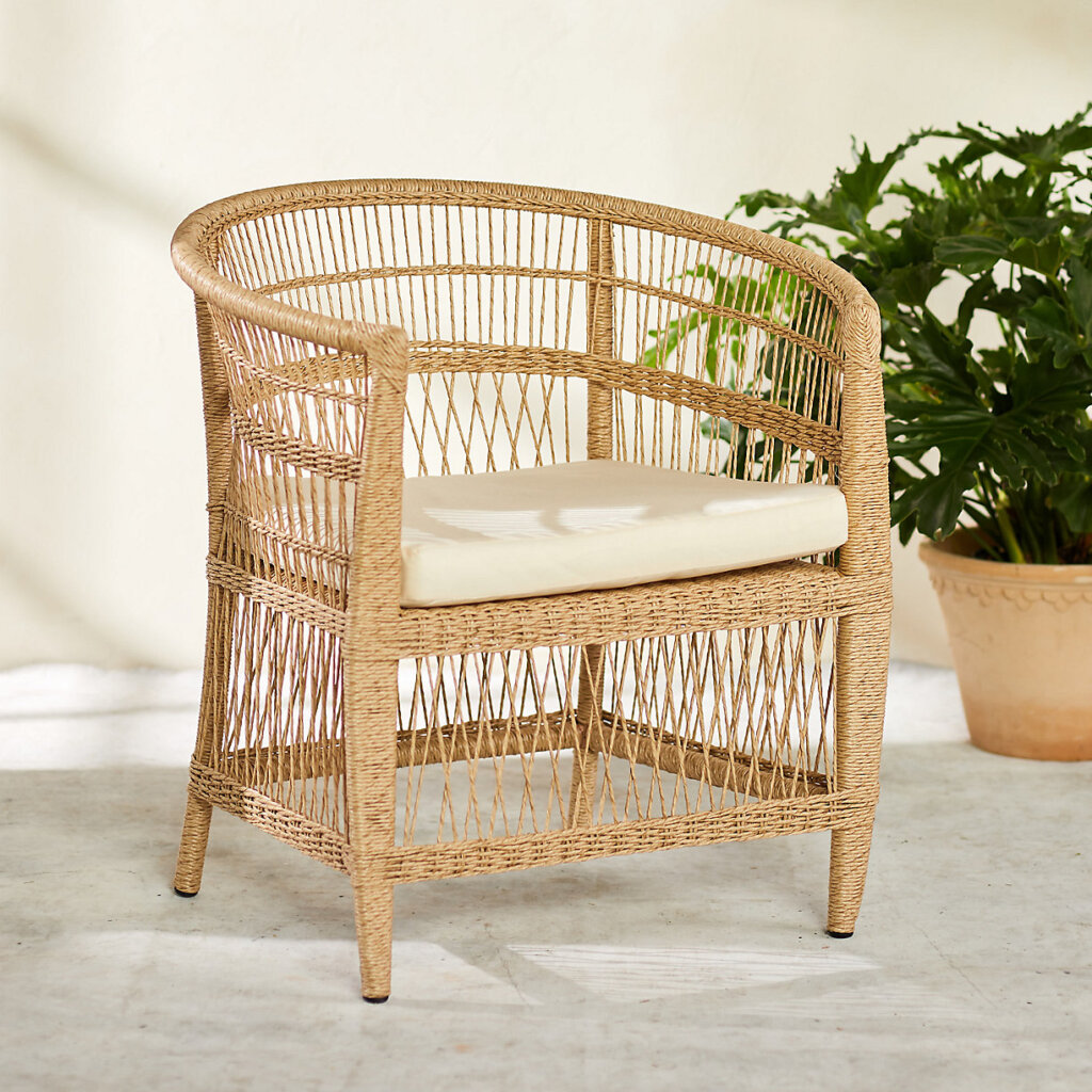 Woven outdoor chair with white cushion