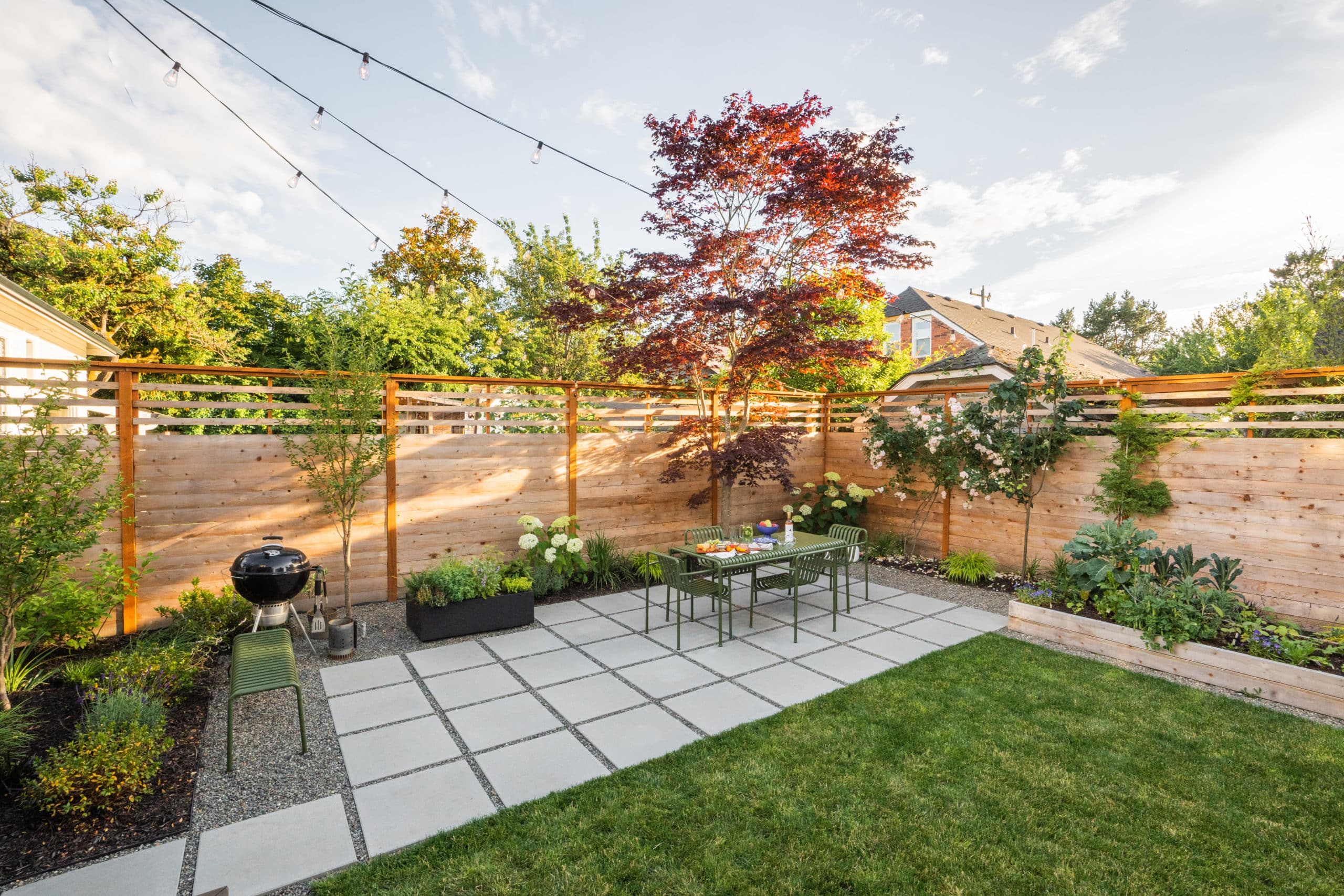 Modern backyard with pavers and outdoor dining area