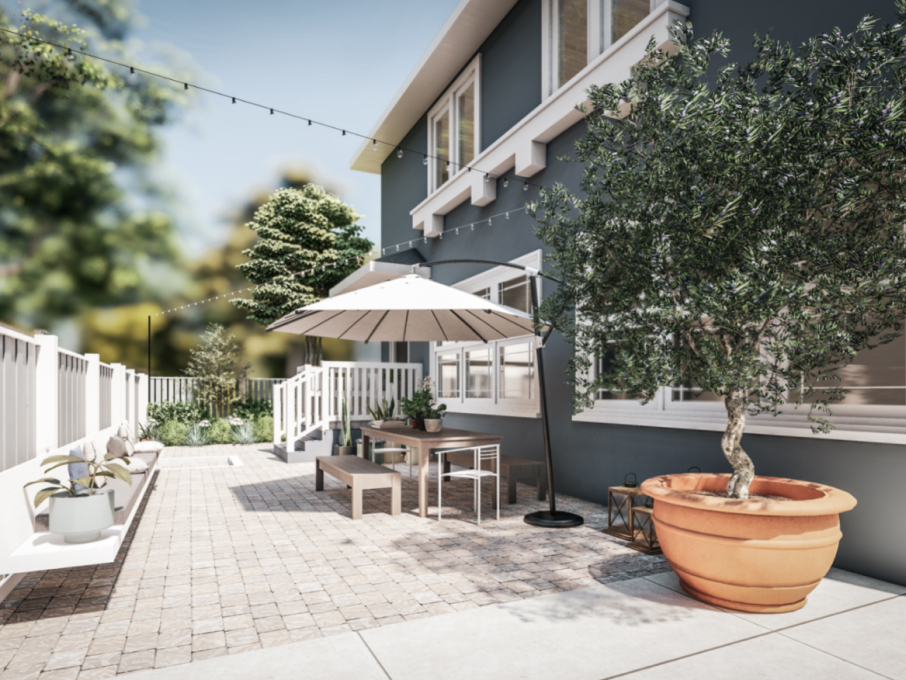 Yardzen 3D Render of a paved patio space with olive tree in a planter and dining table with umbrella, against a blue two story home with white trim