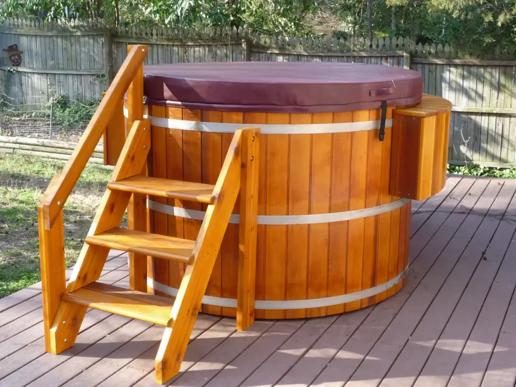 Cedar tub with steps on backyard deck.