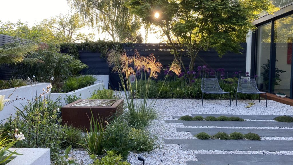 Backyard with gravel and lush plantings