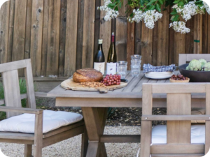 Bread and grapes on a board on a table in the garden.