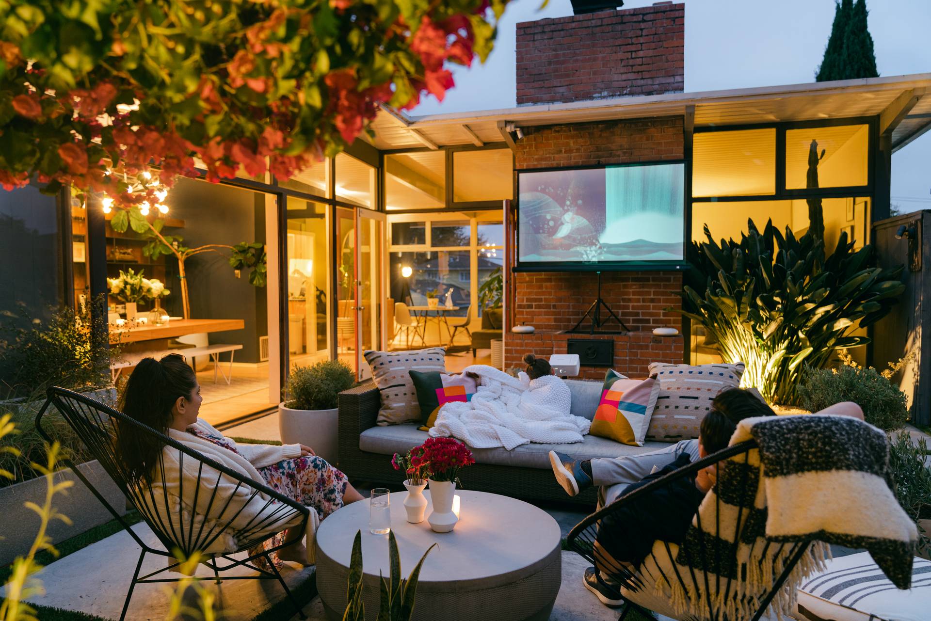 Courtyard movie night with family watching outdoor screen