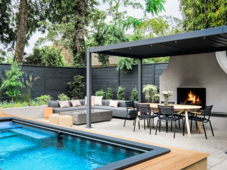 Finished backyard with pool, pergola-covered dining area, and outdoor fireplace