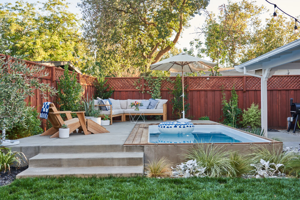 Plunge pool in backyard with sectional couch and chair